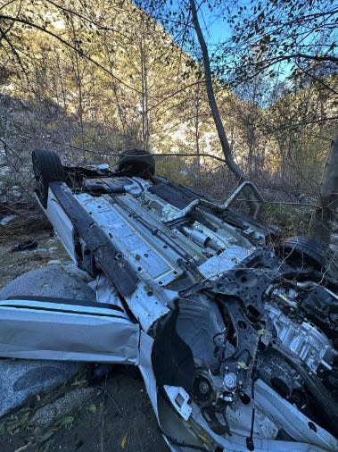 Their car landed upside down after falling from the Angeles Crest Highway.