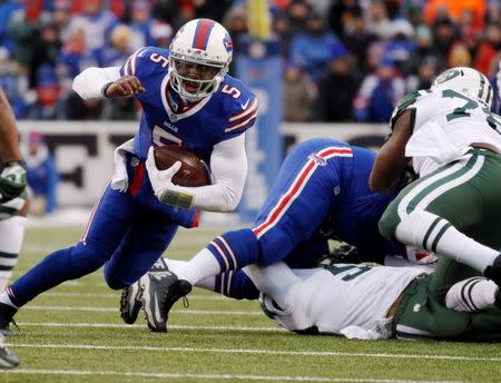 Jan 3, 2016; Orchard Park, NY, USA; Buffalo Bills quarterback Tyrod Taylor (5) runs for a first down during the second half against the New York Jets at Ralph Wilson Stadium. Mandatory Credit: Kevin Hoffman-USA TODAY Sports