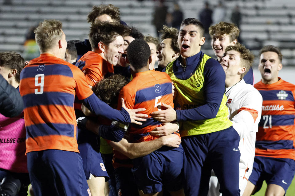 Syracuse players celebrate after winning the NCAA college soccer tournament final against Indiana in Cary, N.C., Monday, Dec. 12, 2022. (AP Photo/Karl B DeBlaker)