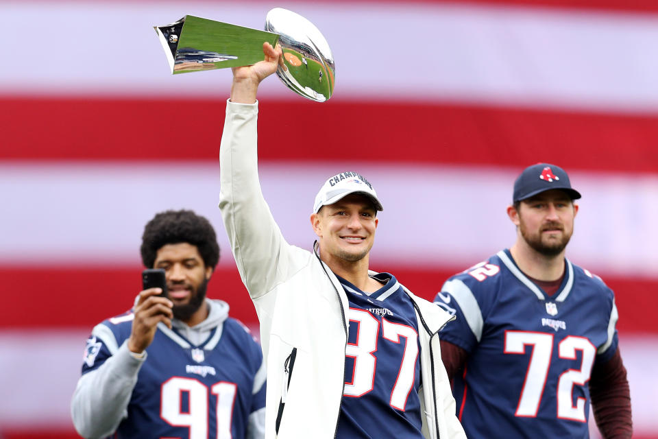 BOSTON, MASSACHUSETTS - APRIL 09: Former New England Patriots player Rob Gronkowski raises the Lombardi Trophy over his head before the Red Sox home opening game against the Toronto Blue Jays at Fenway Park on April 09, 2019 in Boston, Massachusetts. (Photo by Maddie Meyer/Getty Images)