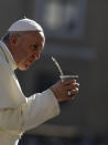 Pope Francis drinks mate offered by a pilgrim as he arrives in St. Peter's Square at the Vatican for his weekly general audience, Wednesday, Sept. 12, 2018. (AP Photo/Alessandra Tarantino)