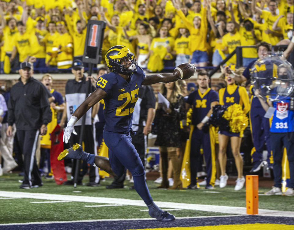 Michigan running back Hassan Haskins rushes for a touchdown during the fourth quarter of the team's NCAA college football game against Washington in Ann Arbor, Mich., Saturday, Sept. 11, 2021. (AP Photo/Tony Ding)