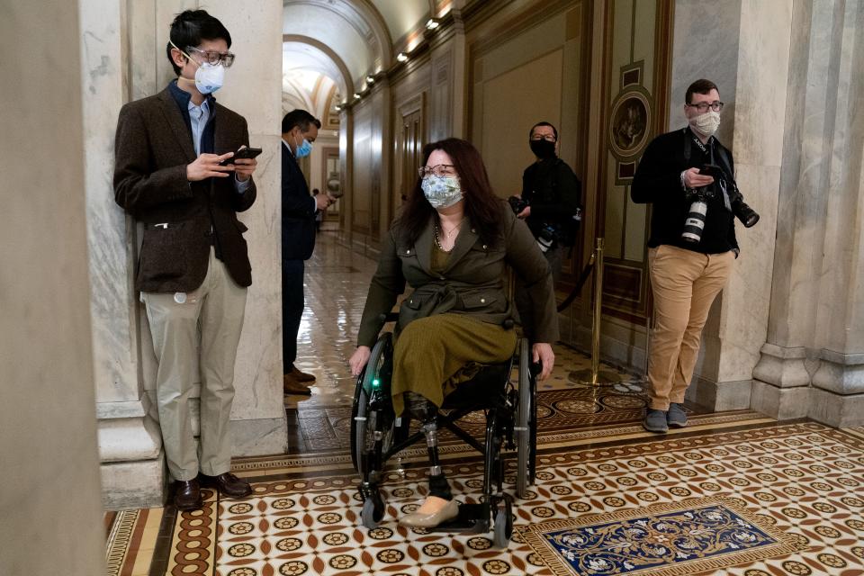 Sen. Tammy Duckworth wears a protective mask at the U.S. Capitol on Feb. 13, 2021. She was wounded in Iraq in 2004 while piloting a Black Hawk helicopter as a member of the Illinois National Guard.