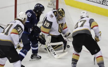 May 20, 2018; Winnipeg, Manitoba, CAN; Vegas Golden Knights goaltender Marc-Andre Fleury (29) makes a save as Winnipeg Jets center Mathieu Perreault (85) looks for the rebound in the second period in game five of the Western Conference Final of the 2018 Stanley Cup Playoffs at Bell MTS Centre. Mandatory Credit: James Carey Lauder-USA TODAY Sports