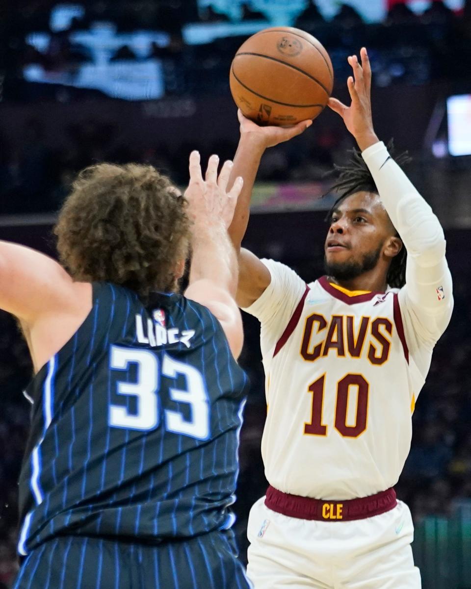 Cavaliers guard Darius Garland (10) shoots over the Orlando Magic's Robin Lopez (33) during the Cavs' 105-92 win Saturday night. Garland led the Cavs with 26 points. [Tony Dejak/Associated Press]