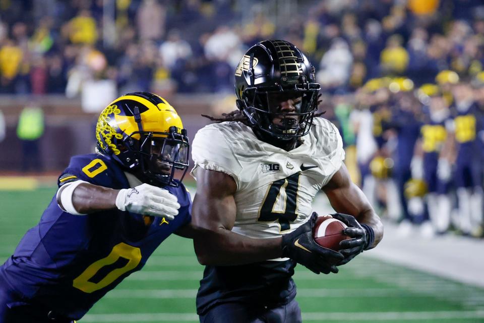 Nov 4, 2023; Ann Arbor, Michigan, USA; Purdue Boilermakers wide receiver Deion Burks (4) makes a reception for a touchdown defended by Michigan Wolverines defensive back Mike Sainristil (0) in the second half at Michigan Stadium. Mandatory Credit: Rick Osentoski-USA TODAY Sports