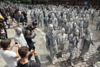 <p>Performance artists covered in clay to look like zombies walk trance-like through the city center on July 5, 2017 in Hamburg, Germany. (Friedemann Vogel/Getty Images) </p>