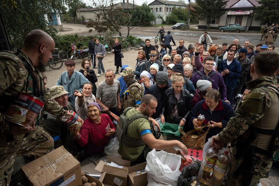 Ukrainian servicemen of Sophia battalion distribute humanitarian aid to local residents in the recently liberated town of Izium, Ukraine, Sunday, Oct. 2, 2022.