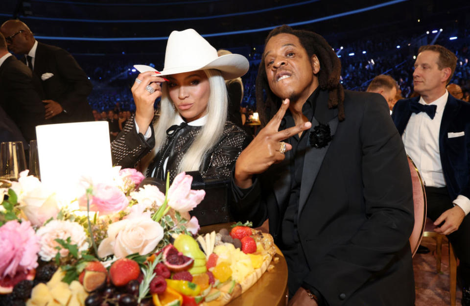 Beyoncé and Jay Z seated at a table during the show