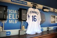 <p>A jersey in tribute to recently decease Miami Marlins pitcher Jose Fernandez (not pictured) hangs in the Los Angeles Dodgers dugout at Dodger Stadium. Mandatory Credit: Gary A. Vasquez-USA TODAY Sports </p>