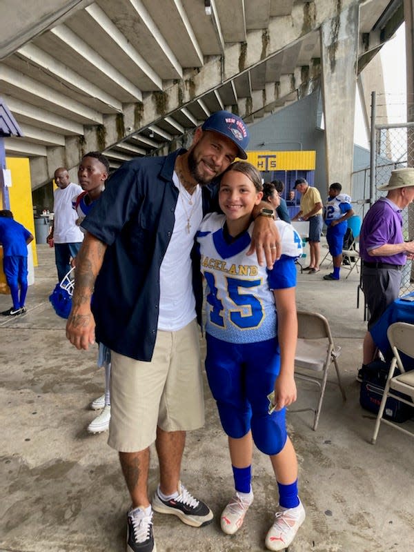 Morgan Fitch and his daughter Harmony Fitch pose at a football jamboree on Thursday, Aug. 18, 2022, in Thibodaux where Harmony played kicker for Raceland Middle School.