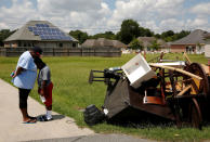 <p>A woman nuzzles her son as they wait to show U.S. President Barack Obama their flood-damaged home as he tours their neighborhood in Zachary, Louisiana, La., Aug. 23, 2016. (Photo: Jonathan Ernst/Reuters) </p>