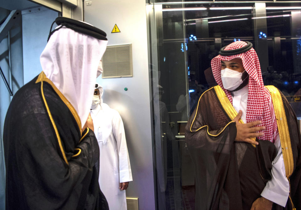 In this photo released by Saudi Royal Palace, Saudi Crown Prince Mohammed bin Salman, right, greets Qatar's Emir Sheikh Tamim bin Hamad Al Thani upon his arrival in the Red Sea city of Jiddah, Saudi Arabia, Monday, May 10, 2021. Qatar's ruling emir is visiting Saudi Arabia for the first time since signing a declaration with other Arab Gulf states to ease a years-long rift and end an embargo that had frayed ties among important U.S. allies and security partners. (Bandar Aljaloud/Saudi Royal Palace via AP)