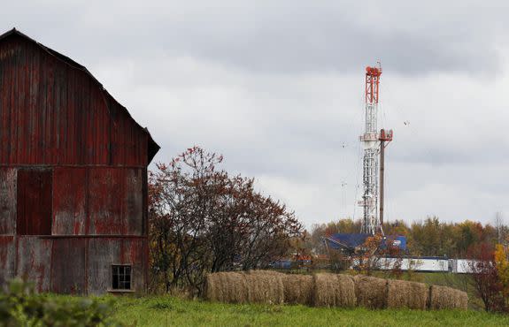 A drilling rig is near a barn and bales of hay in Springville, Pennsylvania.