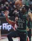 Boston Celtics guard Dennis Schröder, right, shoots as Portland Trail Blazers guard CJ McCollum, left, defends during the first half of an NBA basketball game in Portland, Ore., Saturday, Dec. 4, 2021. (AP Photo/Steve Dipaola)