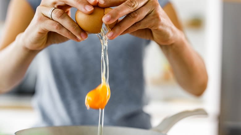 Dropping egg into pan