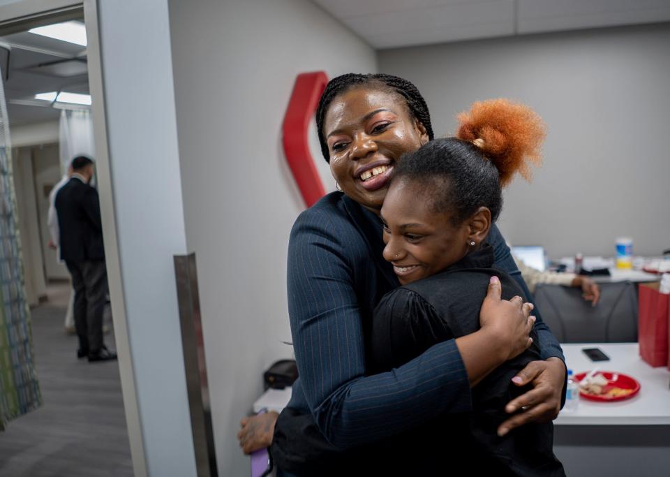 Chinonso Chijioke-Chukwuma, left, of Romulus gives a hug to Naya Williams of Detroit after speaking to her about becoming a pharmacist following a "white coat ceremony" for about 45 pharmacy graduate students that are newly hired to work for CVS Pharmacy serving communities across Michigan at the CVSHealth Workforce Innovation &Talent Center in the Goodwill Industries of Greater Detroit headquarters in Detroit on Tuesday, June 20, 2023. 