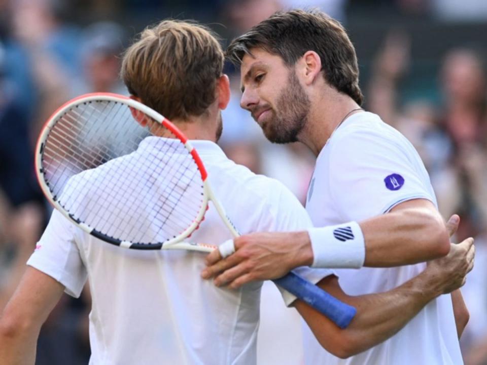 Cameron Norrie and David Goffin embrace at the net after the match (AFP via Getty)