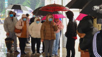 People wear face mask as they stand in line for a free COVID-19 test outside the Lincoln Park Recreation Center in Los Angeles on Thursday, Dec. 30, 2021. More than a year after the vaccine was rolled out, new cases of COVID-19 in the U.S. have soared to their highest level on record at over 265,000 per day on average, a surge driven largely by the highly contagious omicron variant. (AP Photo/Damian Dovarganes)