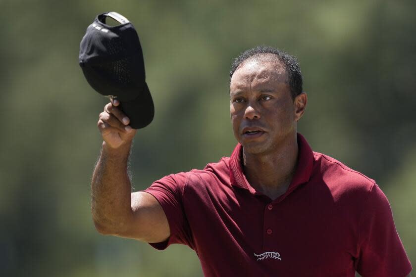 Tiger Woods waves after his final round at the Masters golf tournament at Augusta National Golf Club Sunday, April 14, 2024, in Augusta, Ga. (AP Photo/David J. Phillip)