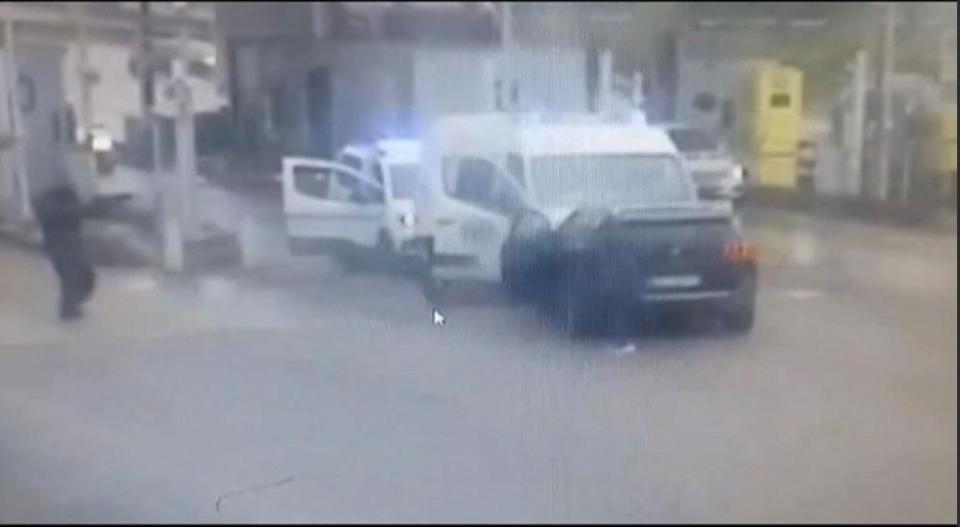 Two gunmen (one left and the other centre) seen after a stolen black Peugeot vehicle rammed a prison van transporting an inmate during an attack in France (AFP via Getty Images)