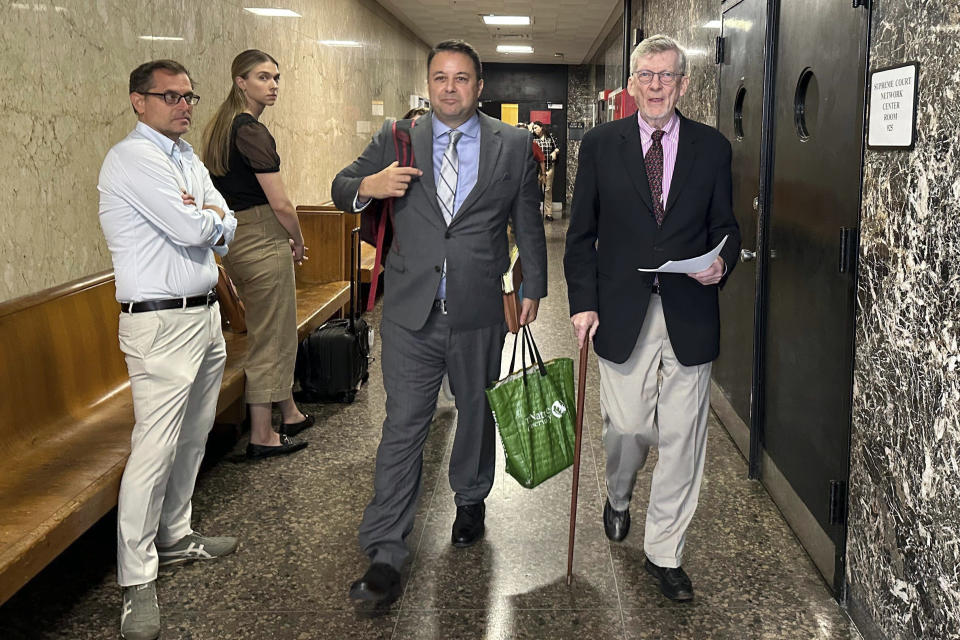 Lawrence Gray, right, a retired political science professor, and his lawyer Christopher Zampogna, center, leave Manhattan criminal court following Gray's arraignment, Tuesday, Aug. 15, 2023, in New York. Gray, 79, pleaded not guilty Tuesday to charges that he robbed four people of rare and valuable pieces that included diamond earrings, a pink sapphire brooch, and a 19th-century gold pocket watch. He earned more than $45,000 in profit selling the stolen goods at a Manhattan auction house, prosecutors alleged. (AP Photo/Jake Offenhartz)