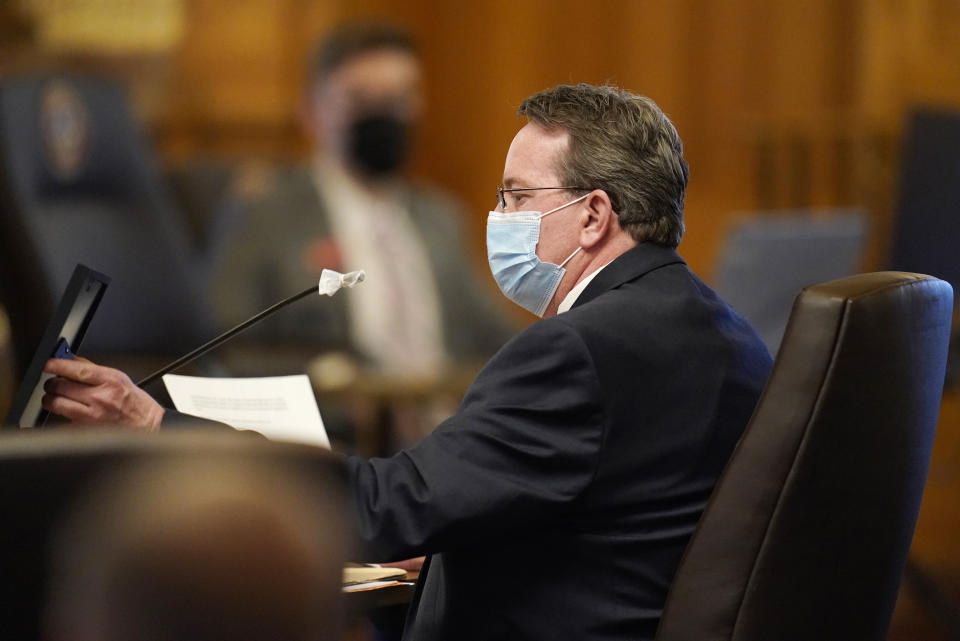 Randy Kady, 54, who was sexually assaulted by a teacher, holds up a photograph of himself as a youth as he talks about the need for the child sexual abuse accountability act during a hearing before the Senate Judiciary Committee in the State Capitol, Thursday, March 11, 2021, in Denver. (AP Photo/David Zalubowski)