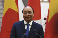 Vietnam's Prime Minister Nguyen Xuan Phuc speaks during a press briefing with Japan's Prime Minister Yoshihide Suga, following an exchange documents ceremony at the Government Office in Hanoi Monday, Oct. 19, 2020.(Nhac Nguyen/Pool Photo via AP)