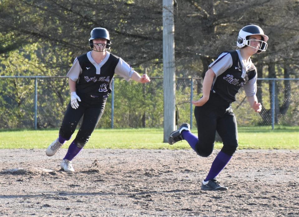 Mountie Makaylah Mowers follows Little Falls teammate Anna Sadekoski (right) around the bases on the first of her two home runs Monday against Dolgeville at the Veterans Memorial Park complex.