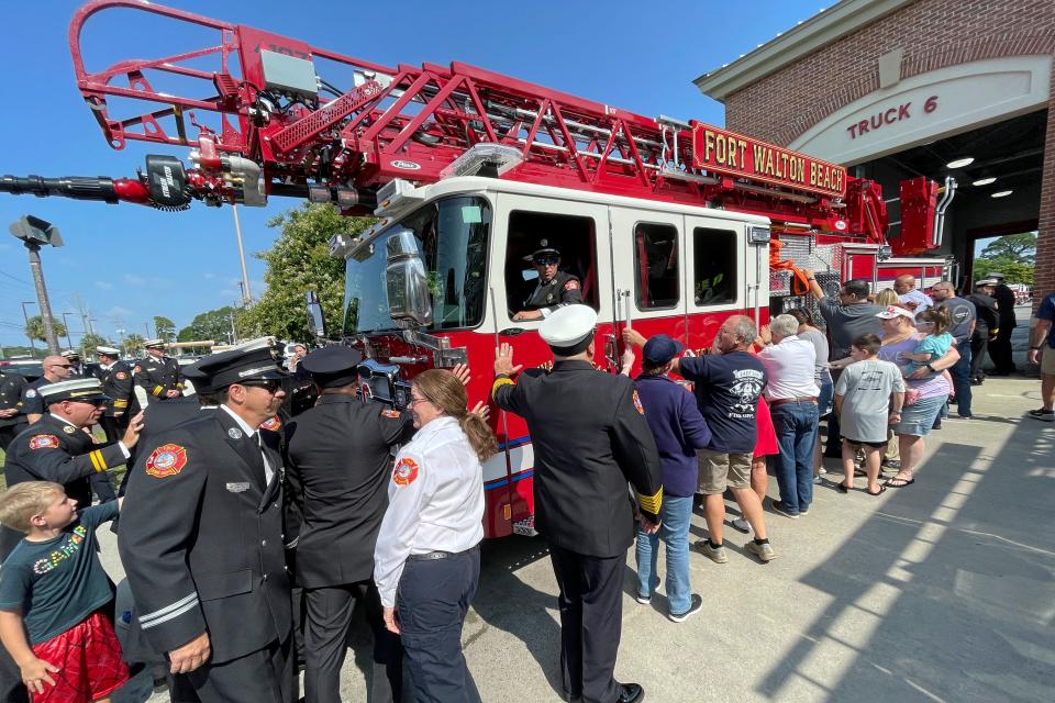 Fort Walton Beach firefighters, city officials and residents help "push in" a new firetruck Tuesday at the department's Station 6.