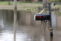 A mailbox that was almost underwater Monday, is now a couple of feet above the Pearl River floodwaters on North Canton Club Circle in Jackson, Miss., Tuesday afternoon, Feb. 18, 2020. Officials have limited entry to the flooded neighborhoods as they have warned residents about the contamination of the receding waters and the swift currents. (AP Photo/Rogelio V. Solis)