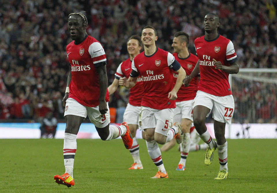 Arsenal's players celebrate their win against Wigan Athletic at the end of their English FA Cup semifinal soccer match at Wembley Stadium in London, Saturday, April 12, 2014. (AP Photo/Sang Tan)
