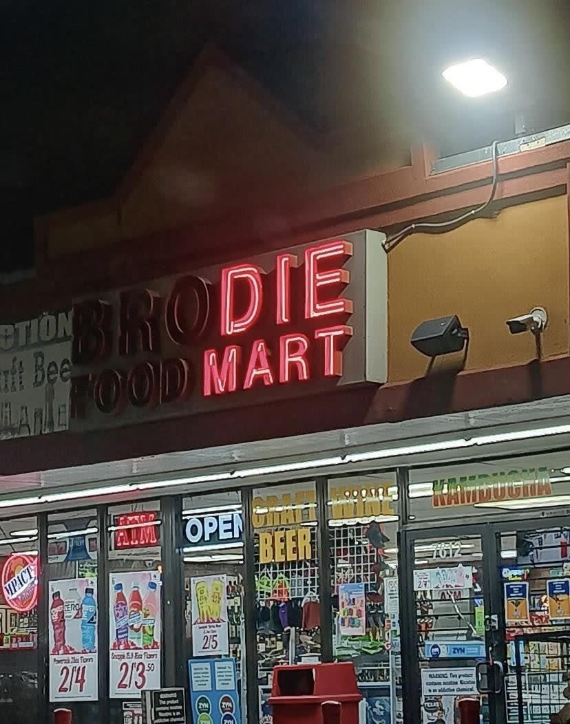 Brodie Food Mart sign that reads "die mart" due to burnt out letters