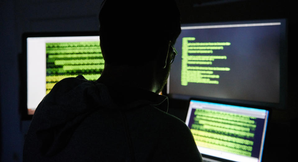 ILLUSTRATION - 16 July 2019, Berlin: A man sits in front of three screens with text. Photo: Annette Riedl/dpa-Zentralbild/dpa (Photo by Annette Riedl/picture alliance via Getty Images)