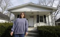 Regina Bachman stands outside her home that has a small creek running behind it in Loveland, Ohio on Friday, March 21, 2014. Bachman bought the home in September 2013 and was initially told by the bank that flood insurance on the property would be affordable, only to find out after closing that the rates were going to increase over $7,000 more annually with new premiums for the National Flood Insurance Program. (AP Photo/Al Behrman)