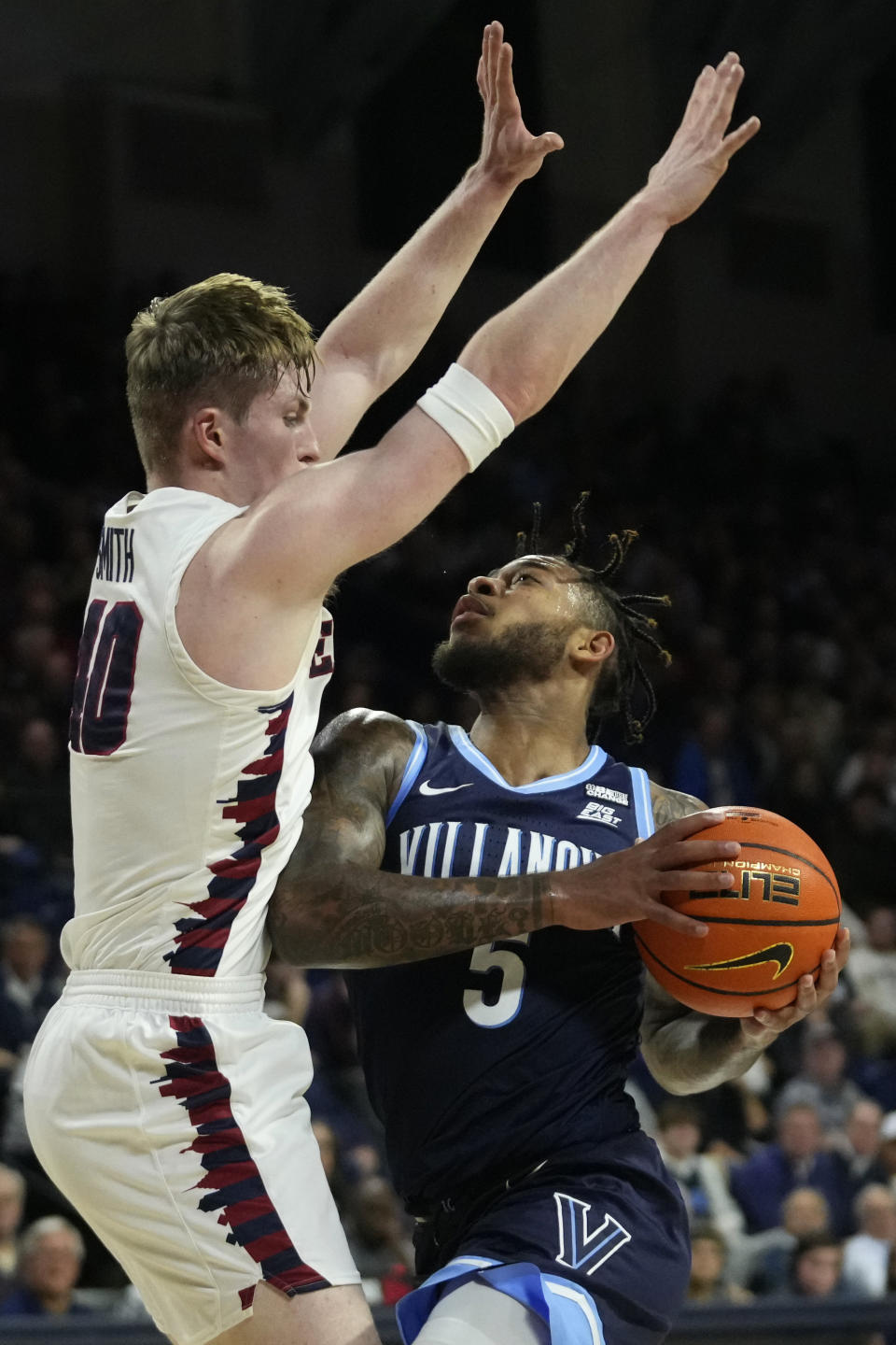 Villanova's Justin Moore, right, tires to get past Pennsylvania's George Smith during the first half of an NCAA college basketball game, Monday, Nov. 13, 2023, in Philadelphia. (AP Photo/Matt Slocum)