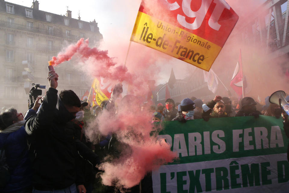 Protesters march behind a banner reading "Paris will block the far right" during a demonstration against French presidential candidate Eric Zemmour, Sunday, Dec. 5, 2021 in Paris. French far right presidential candidate Eric Zemmour holds his first campaign rally in Villepinte, north of Paris. A first round is to be held on April, 10, 2022 and should no candidate win a majority of the vote in the first round, a runoff will be held between the top two candidates on April 24, 2022. (AP Photo/Michel Spingler)