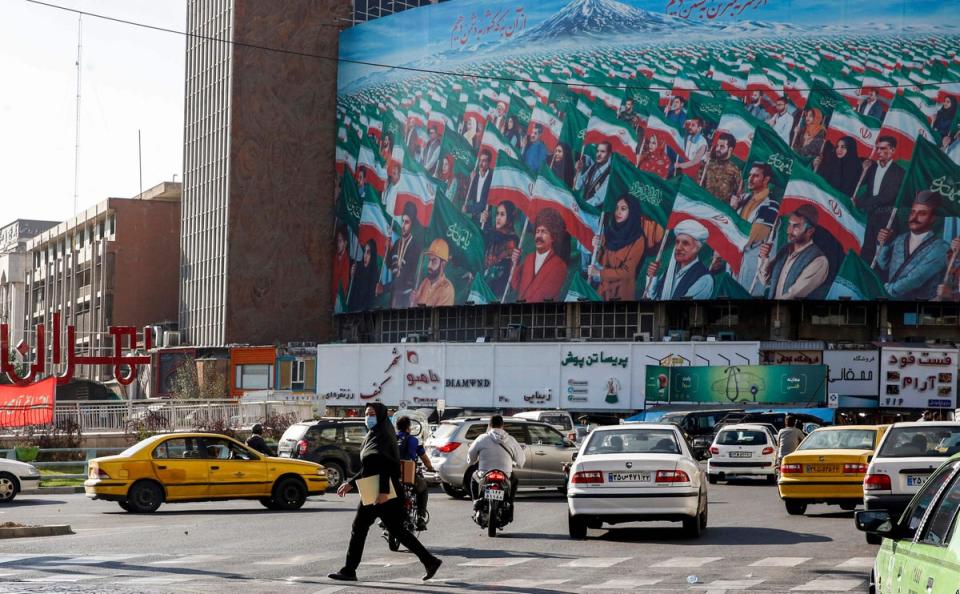 People walk across a pedestrian crossing in Valiasr square in the centre of Iran's capital Tehran (AFP via Getty Images)