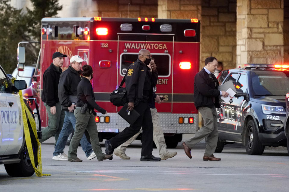 Police officials walk to the Mayfair Mall, Friday, Nov. 20, 2020, in Wauwatosa, Wis. Multiple people were shot Friday afternoon at the mall and police are still searching for the shooter. (AP Photo/Nam Y. Huh)