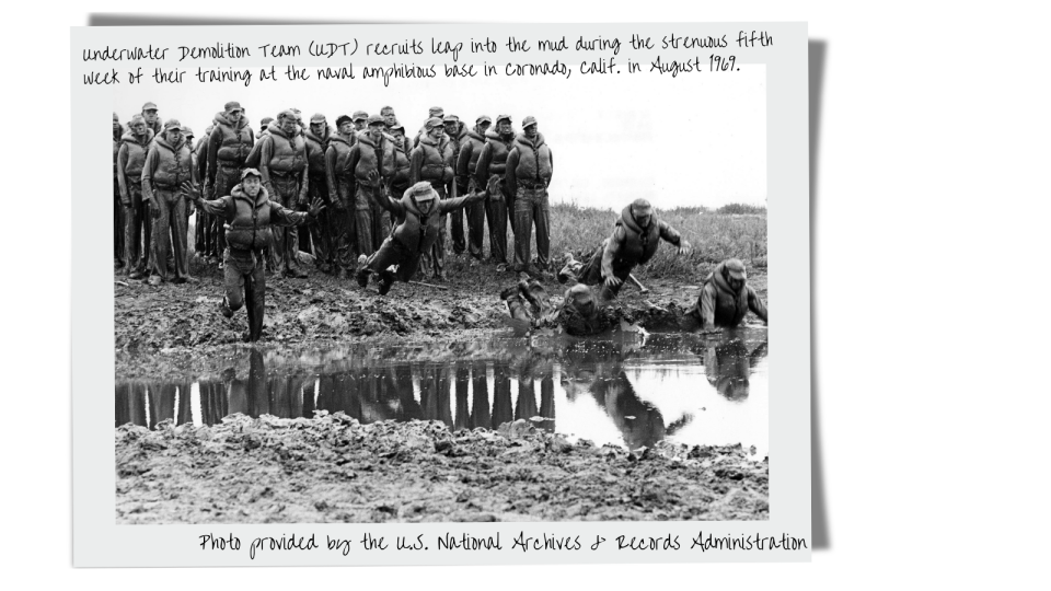 Underwater Demolition Team (UDT) recruits leap into the mud during the strenuous fifth week of their training at the naval amphibious base in Coronado, Calif. in August 1969.