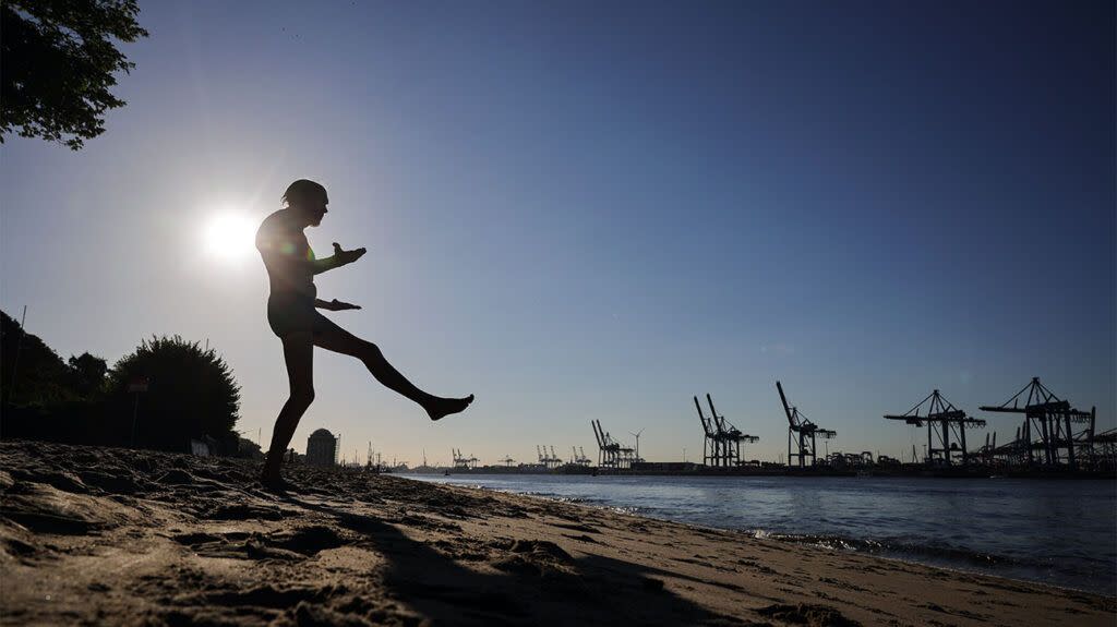 A man getting ready to jump into the sea at a beach