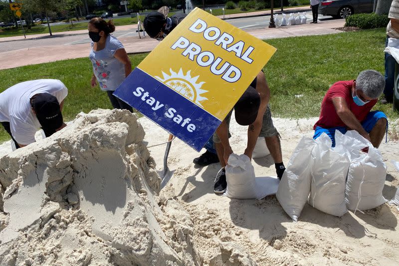 Residents fill and collect sand bags before the expected arrival of Hurricane Isaias in Doral