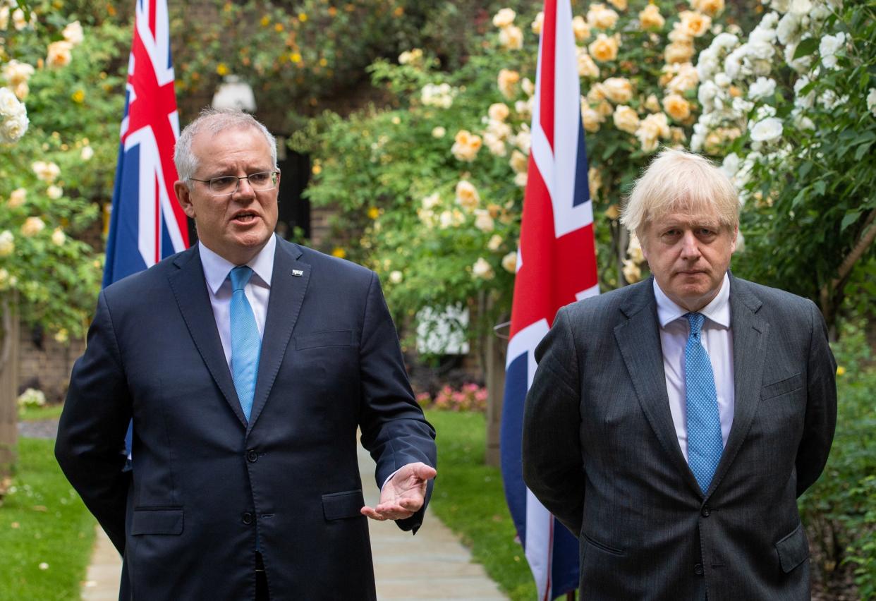 Boris Johnson looks on as Australia’s Prime Minister Scott Morrison speaks at No10 on Tuesday (REUTERS)