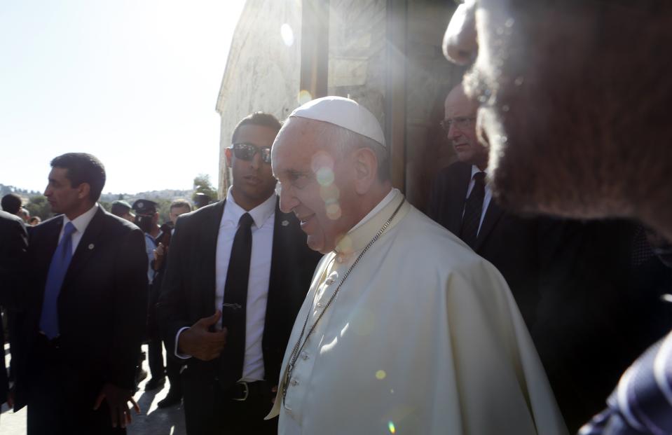 Pope Francis is accompanied by security personnel during his visit at Jerusalem's Old City