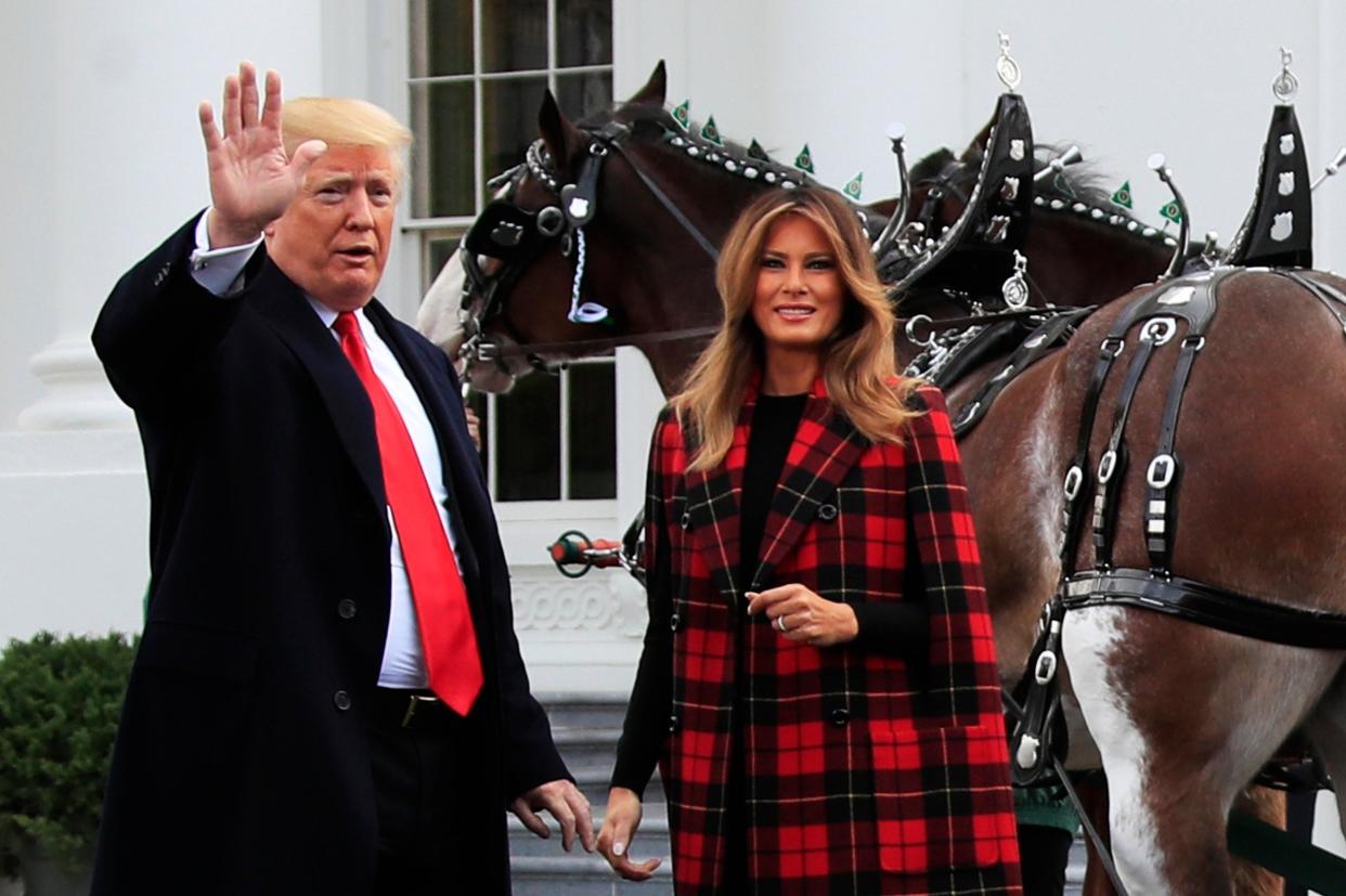 President Donald Trump and first lady Melania Trump wave during a ceremony to receive the White House Christmas Tree (AP)