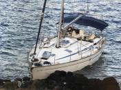 A sailboat is seen abandoned on the southern island of Kythera, Greece, on Wednesday, Aug. 17, 2022. The sailboat carried 97 migrants ran aground in Kythera in the early hours of the morning as a second boat arrive with dozens people on the island on Wednesday noon. (Giorgos Samios/kythera.news via AP)