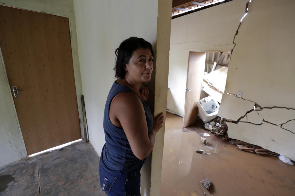 Isamara de Araujo stands inside her partially destroyed house after a dam collapsed in Brumadinho, Brazil, Saturday, Jan. 26, 2019. An estimated 300 people were still missing and authorities expected the death toll to rise during a search made more challenging by intermittent rains. (AP Photo/Andre Penner)