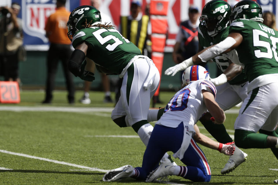 New York Jets inside linebacker C.J. Mosley (57) runs back and interception for a touchdown during the first half of an NFL football gameas Buffalo Bills' Cole Beasley (10) watches Sunday, Sept. 8, 2019, in East Rutherford, N.J. (AP Photo/Seth Wenig)