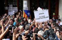 A crowd of protesters lift up a ballot box outside the Catalan region's economy ministry building after junior economy minister Josep Maria Jove was arrested by Spanish police during a raid on several government offices, in Barcelona, Spain, September 20, 2017. REUTERS/Albert Gea