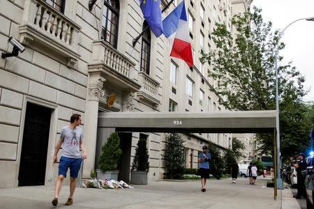 People pass by a makeshift memorial at the Consulate General of France in Manhattan following the Nice terror attack in New York, U.S., July 16, 2016. REUTERS/Eduardo Munoz